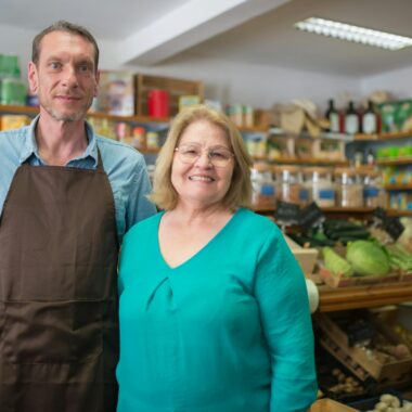 Friendly couple in a cozy organic store, highlighting community business.